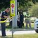 An Ann Arbor police officer ties caution tape to a crosswalk sign after a pedestrian was struck by a car while attempting to cross Plymouth Rd. between Traverwood Dr. and Nixon Rd. on Wednesday, August 7, 2013. Melanie Maxwell | AnnArbor.com 